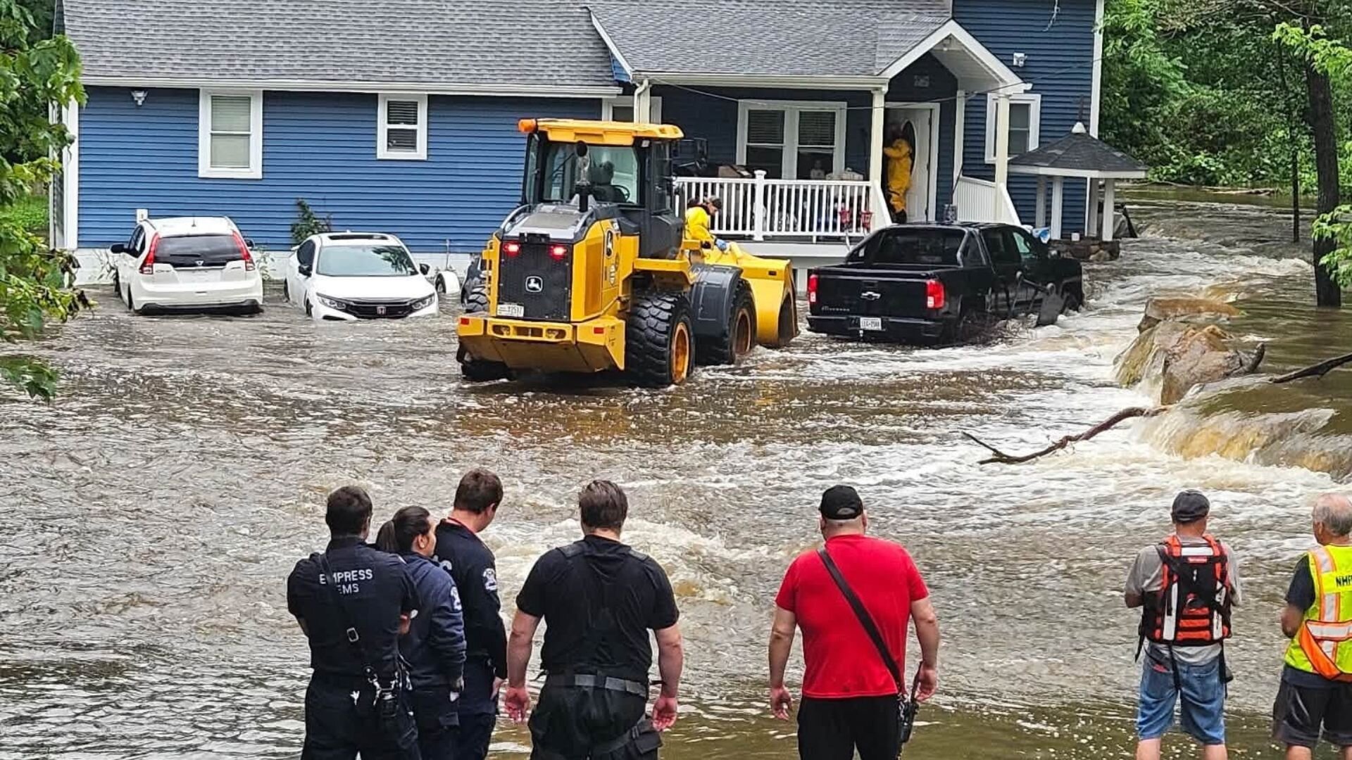Family rescued from flooded home by firefighters using front-end loader in Putnam County