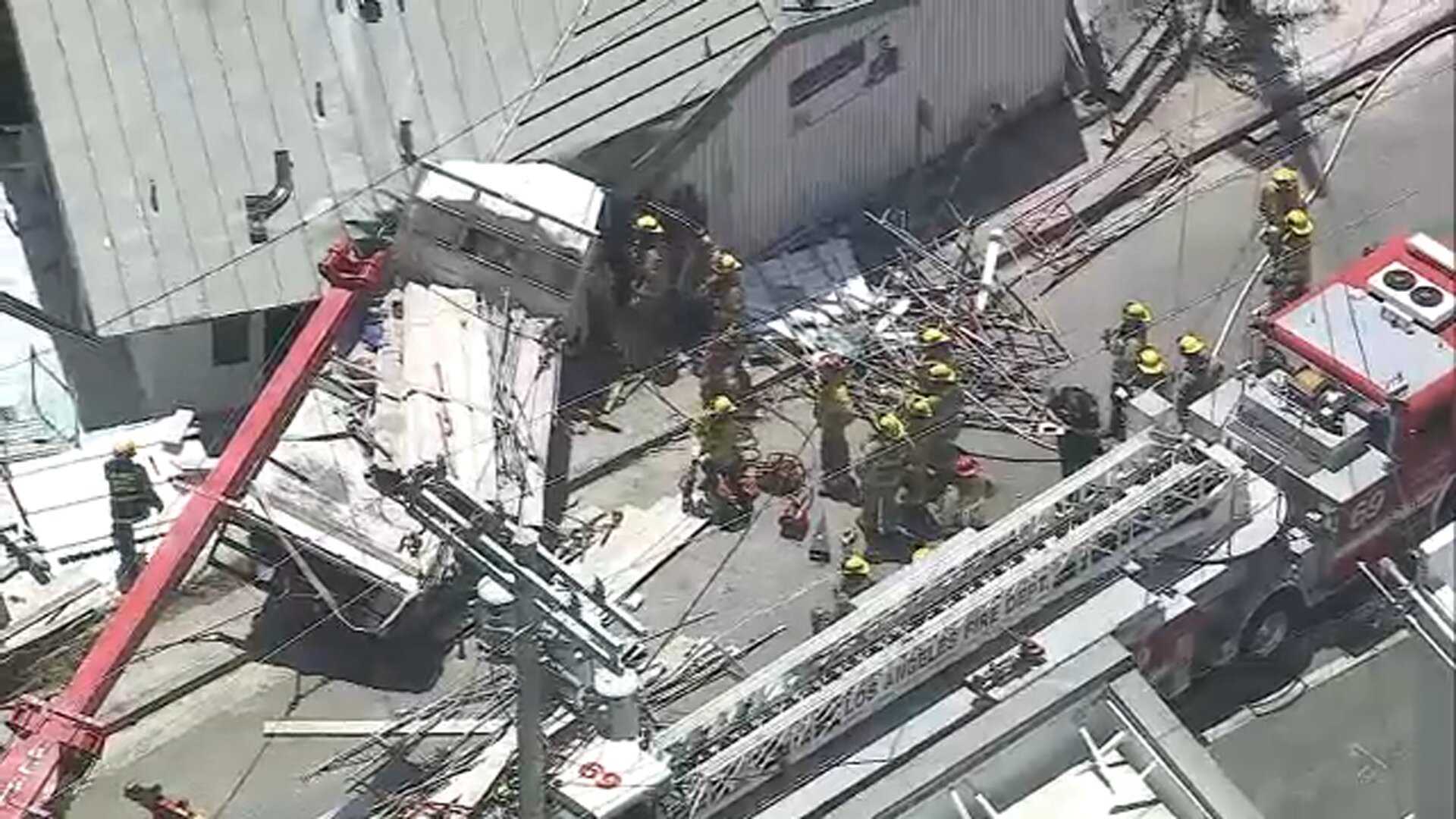 Firefighters rescue trapped driver after flatbed truck slams into building in Pacific Palisades