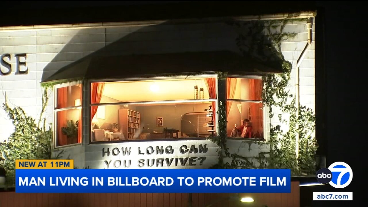Man living inside billboard on Sunset Boulevard to promote film draws spectators