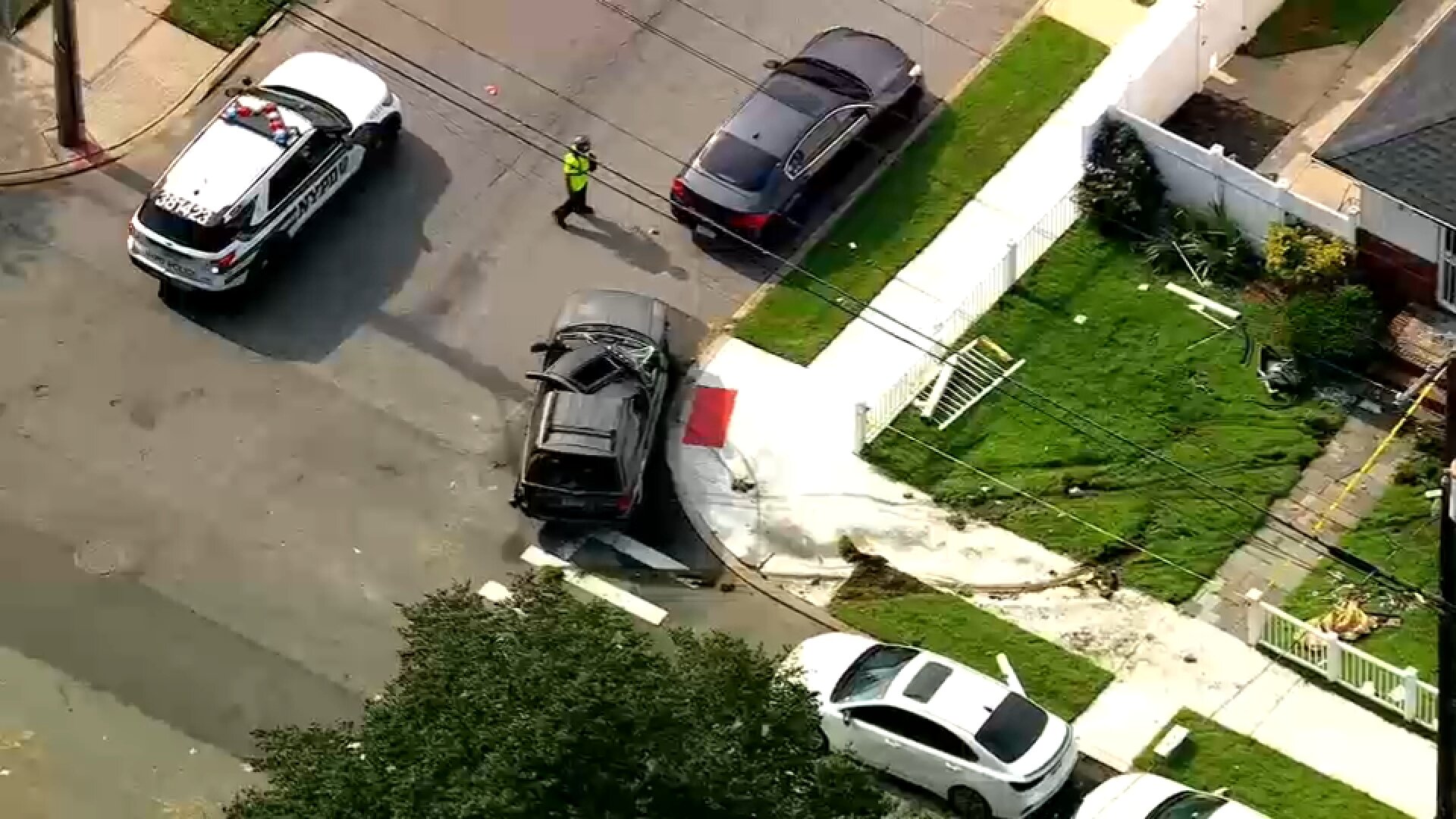 SUV rolls over, crashes into Jamaica, Queens home; driver rushed to hospital