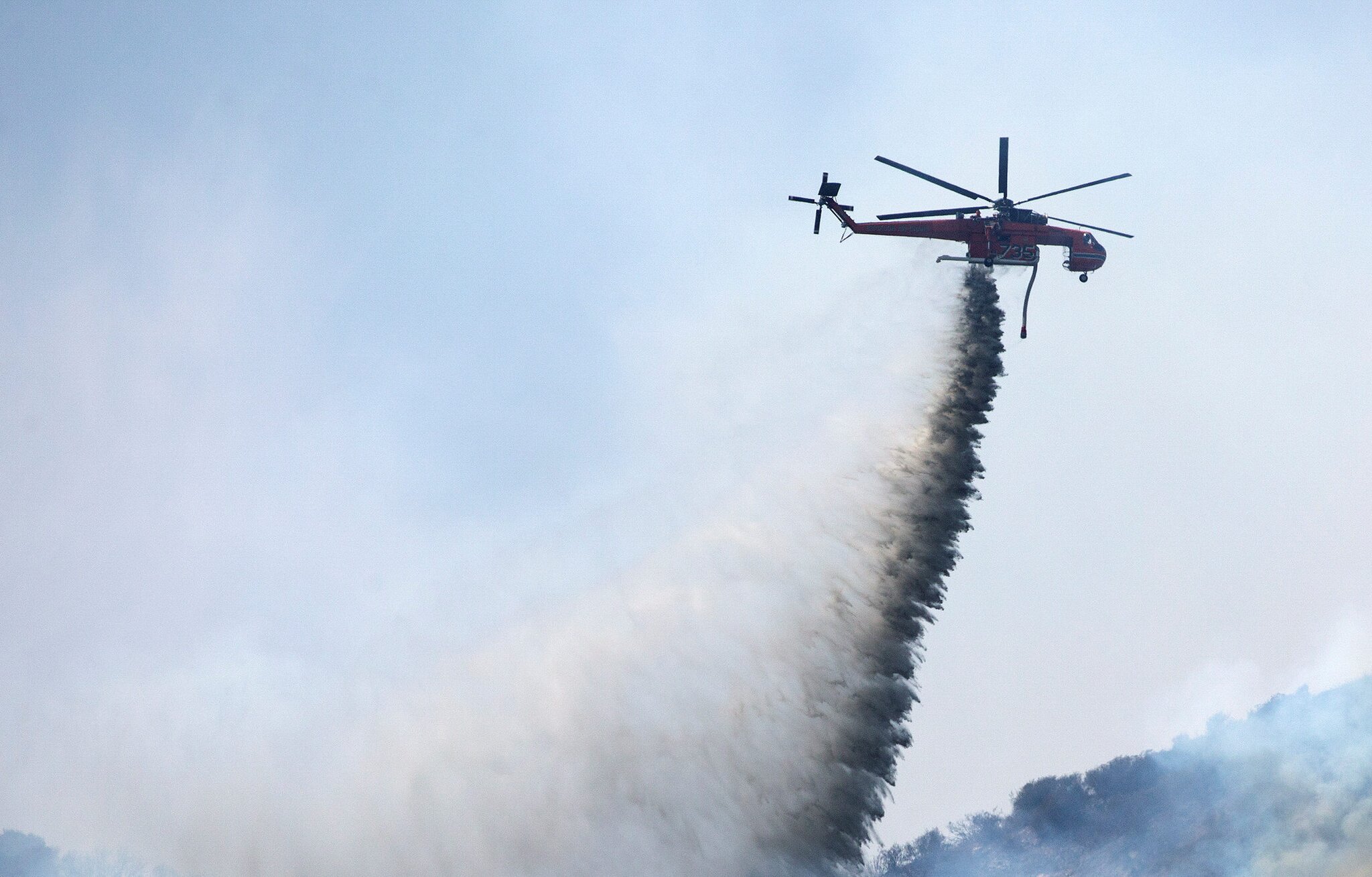 Helicopter battling Utah wildfire crashes with no word on the 2 people aboard
