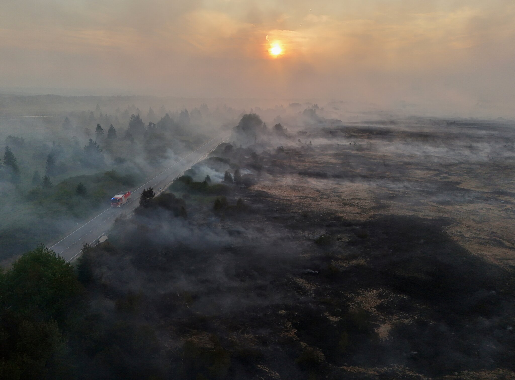 Firefighters battle massive wildfires in Belgium and Greece as 2 die on an island near Athens