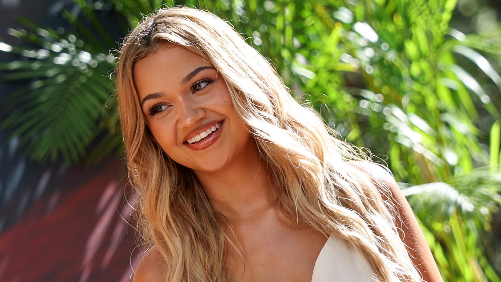 Outer Banks’ Star Madison Bailey On Show’s “Lack Of Queer Representation,” Desire To Play LGBTQ Role: “I’ve Been Manifesting It
