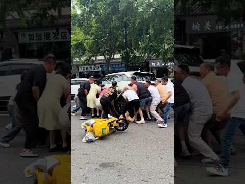 Bystanders lift car off young woman in China