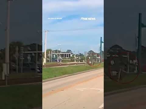 Man lifts railroad gate SAVING woman from oncoming train #shorts #us #news #foxnews