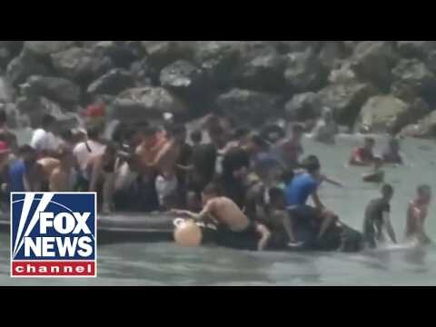 Migrants storm city border as national emergency requested