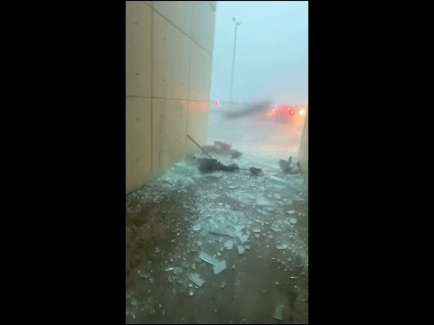 Officer narrowly escapes from falling glass