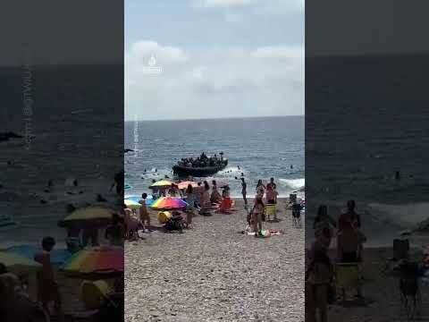 Dozens of migrants land on Spanish coast surprising beachgoers