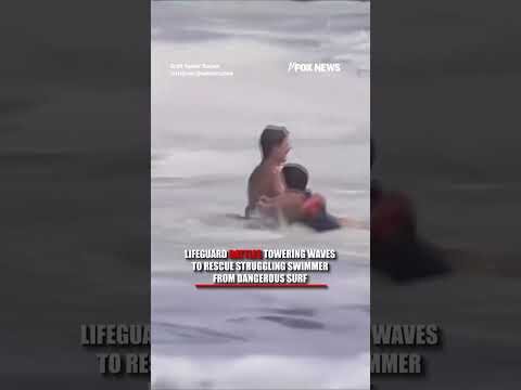 Lifeguard battles TOWERING waves to rescue struggling swimmer #shorts #us #news #foxnews #viral
