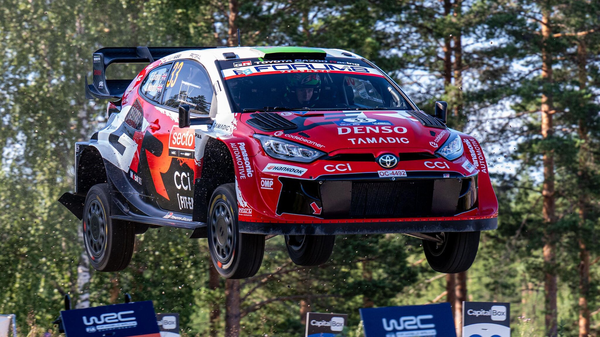 Evans third after roll as Ogier taken to hospital