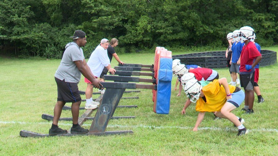 High school football players embrace first day of fall practice
