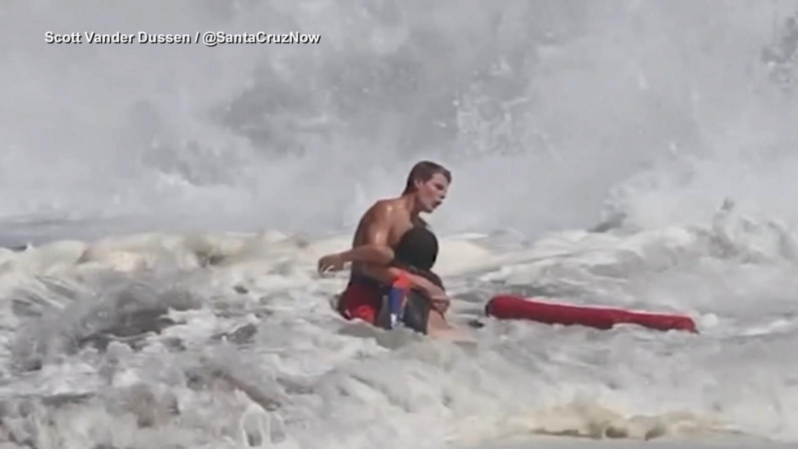 Lifeguard fights to rescue boy caught in high surf