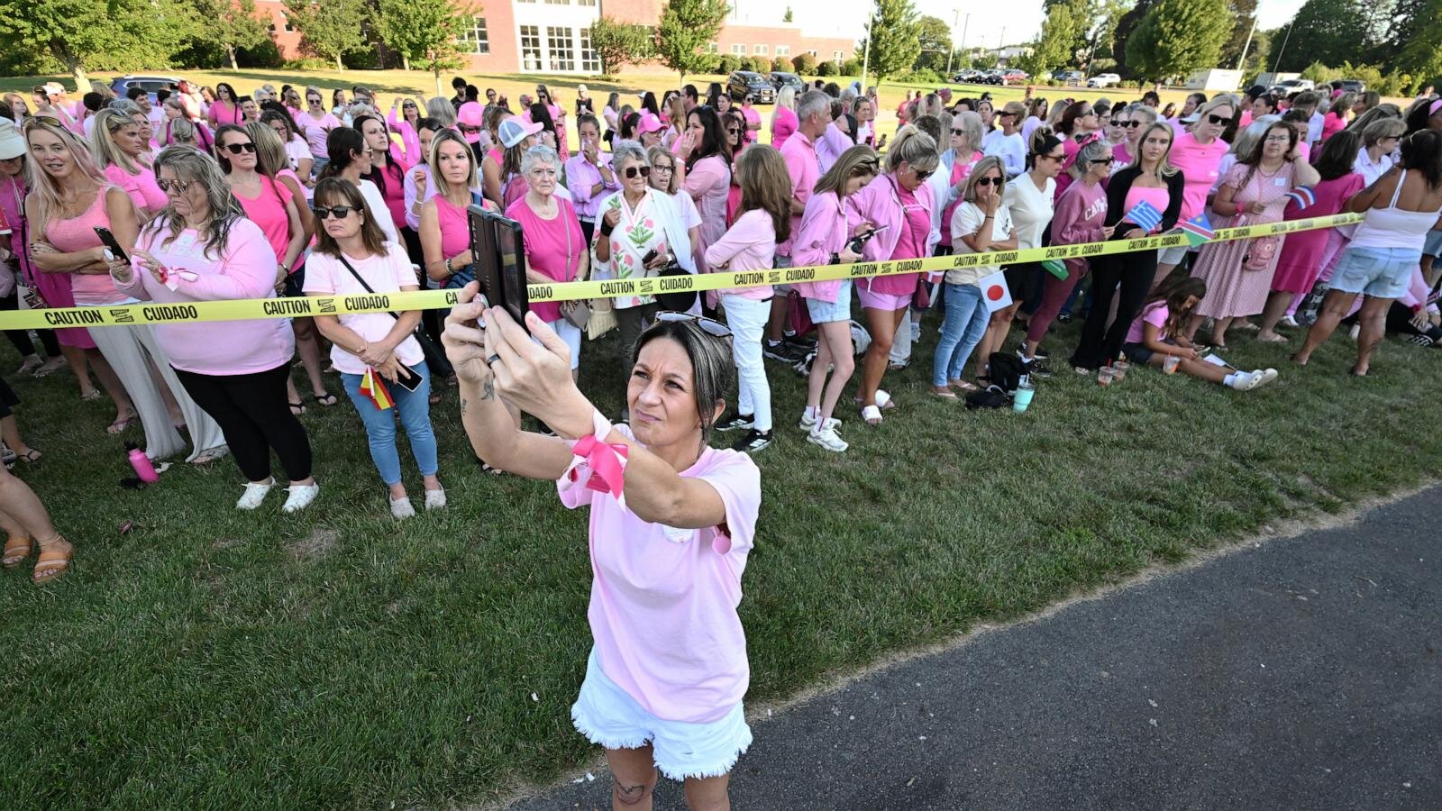 Women in pink rally in support of Lindsay Clancy who is on trial for killing 3 children