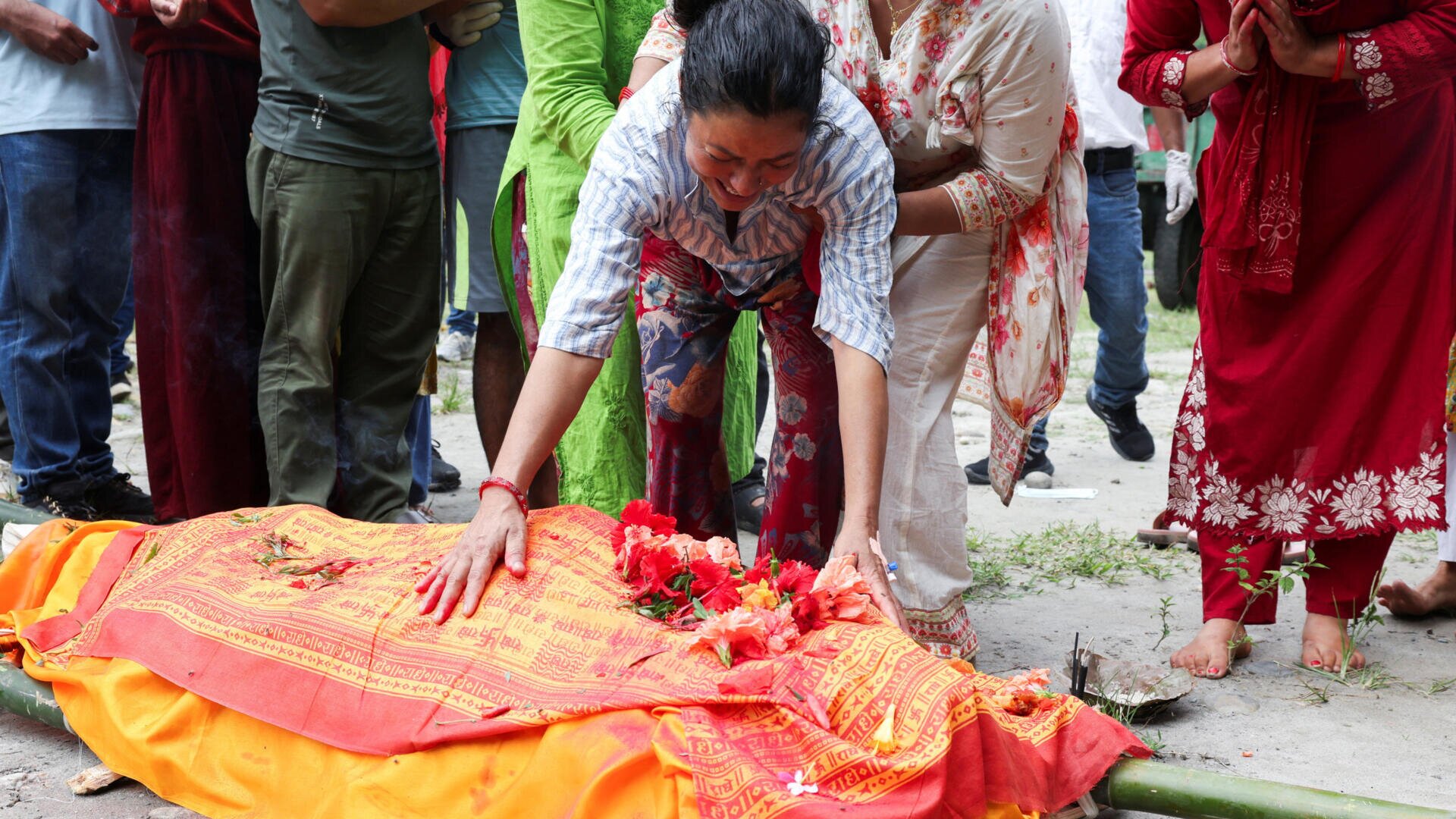 Nepal starts burying its dead as search for over 4,200 missing continues