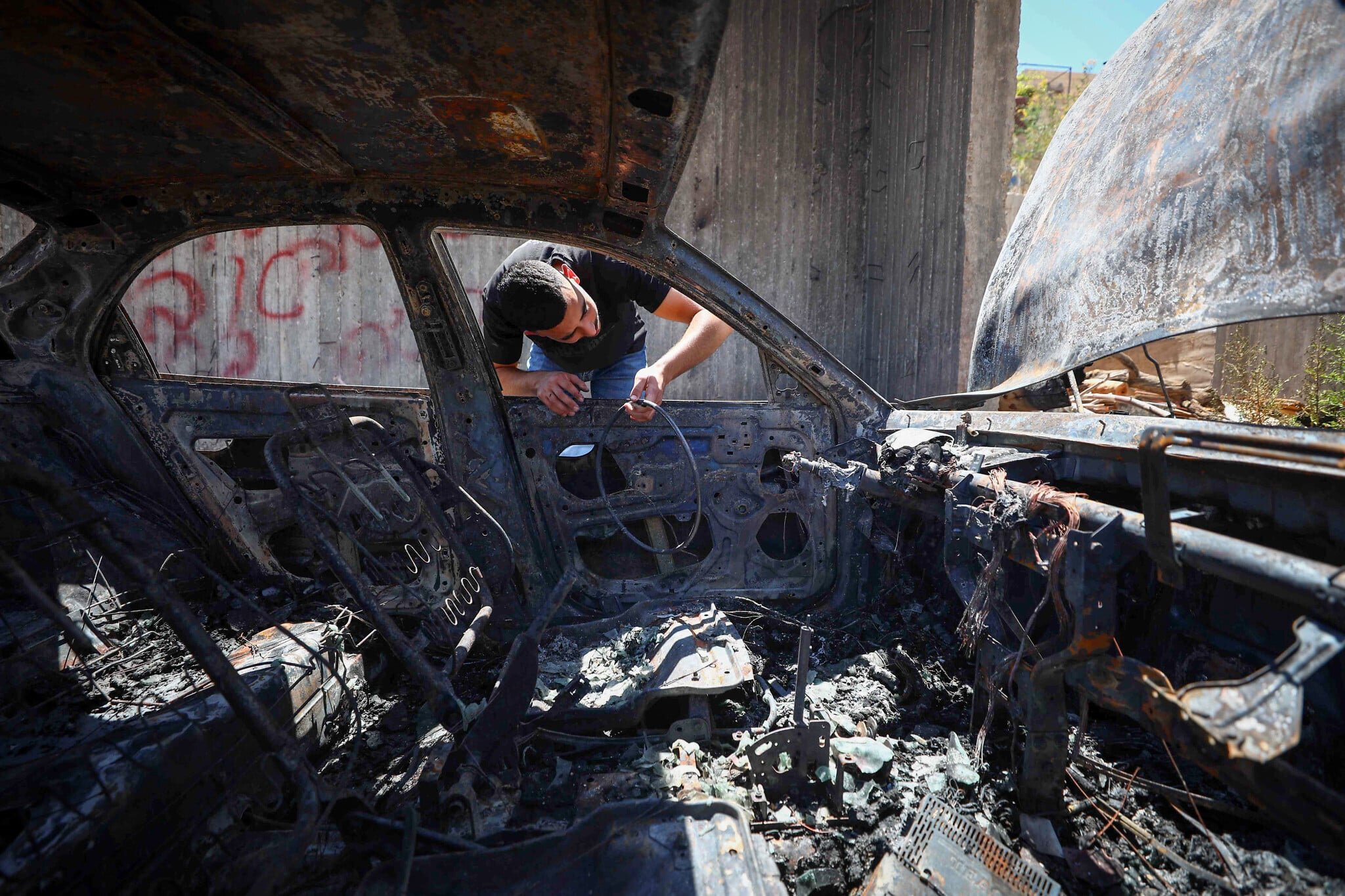 Settlers assault Palestinians, burn cars in overnight West Bank raid; no arrests